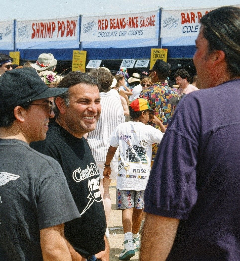 Members of Los Lobos waiting in line for food at the New Orleans Jazz and Heritage Festival